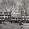 <p>The staff and students of the Army Chaplain School at Fort Slocum, under the command of Chaplain Col. Edward Donahue, in front of the former Post Hospital, then in use as the school headquarters, 1956.</p>